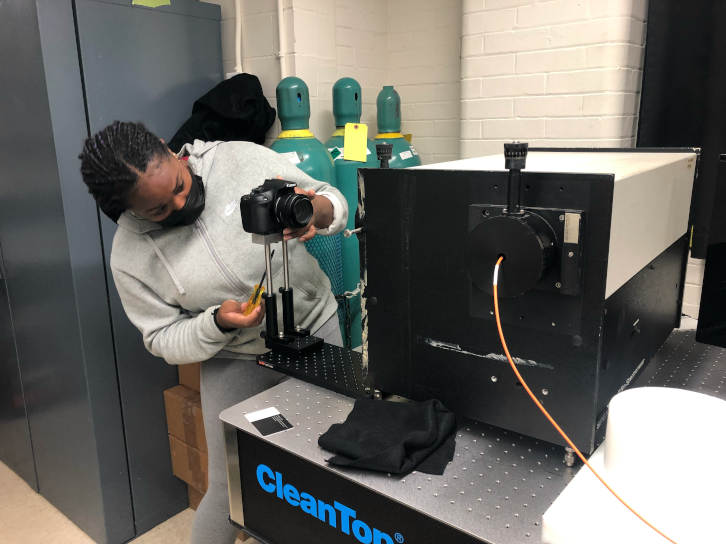 High school student setting up a spectrometer