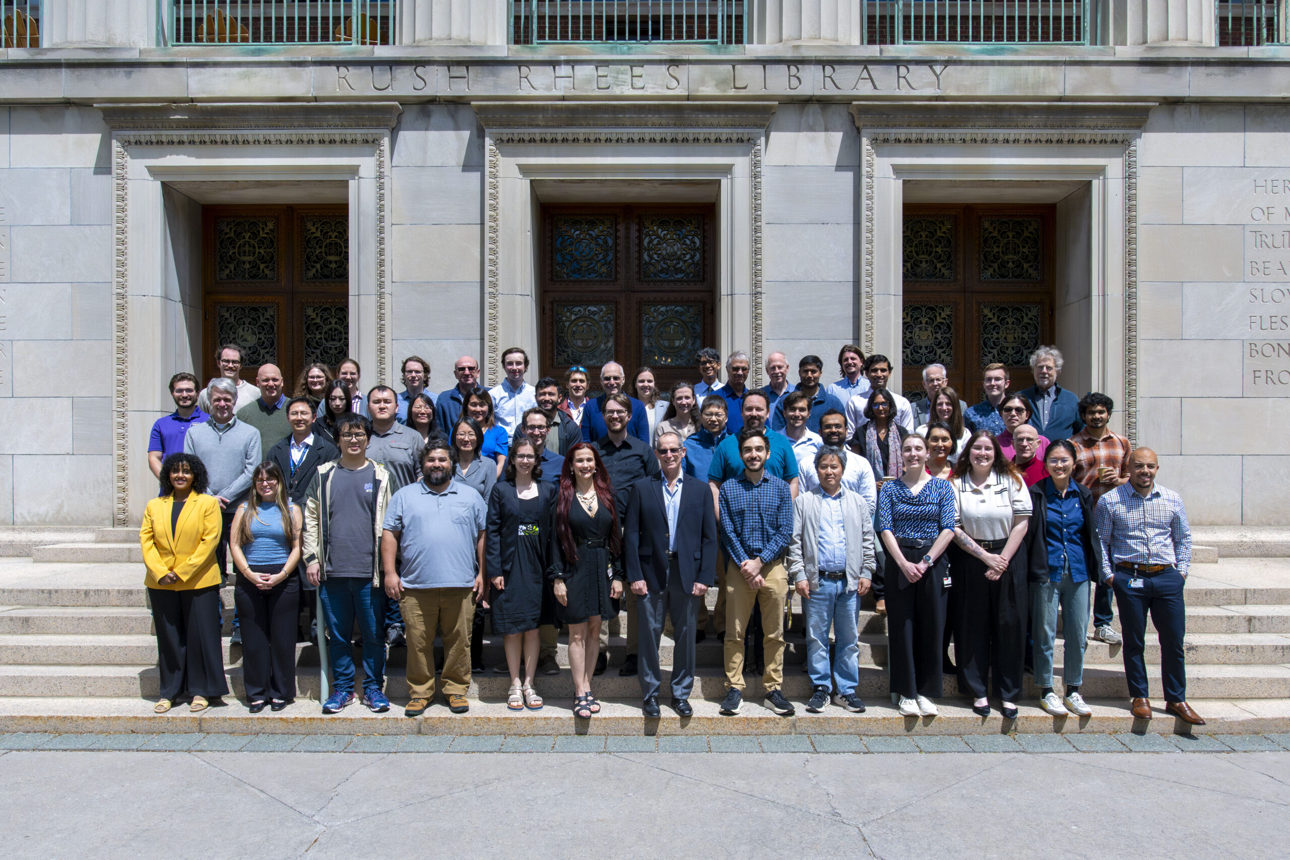 Group of all in-person CMAP attendees standing in front of the University of Rochester's Rush Rhees Library.