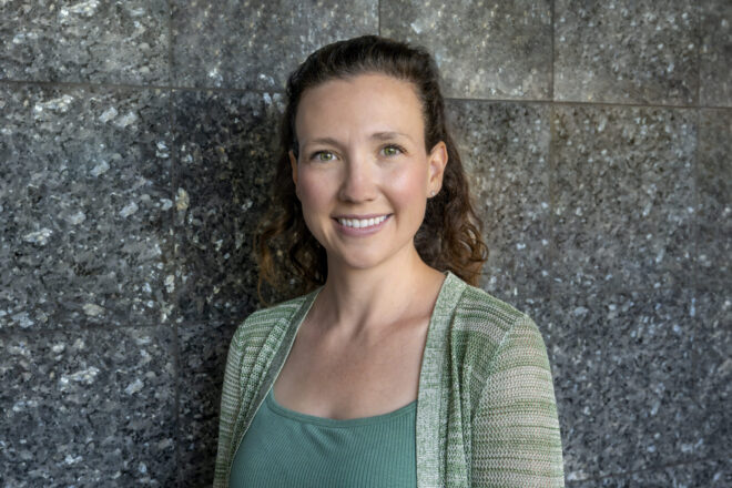 Portrait photo of Danae Polsint in front of granite wall in the LLE East Lobby.